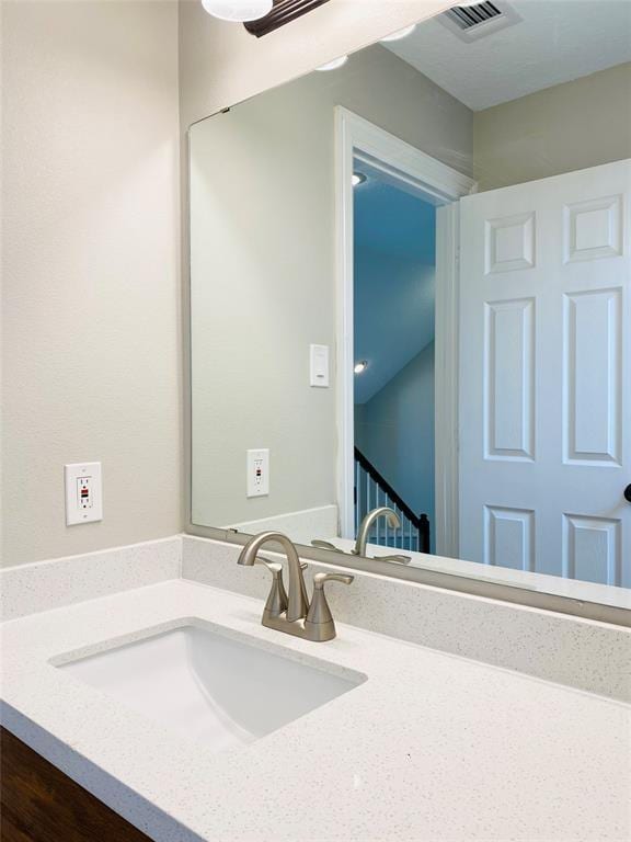 bathroom featuring vanity and visible vents