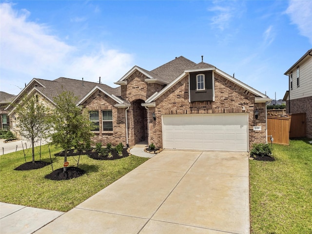 traditional-style home featuring brick siding, a front lawn, a garage, and concrete driveway