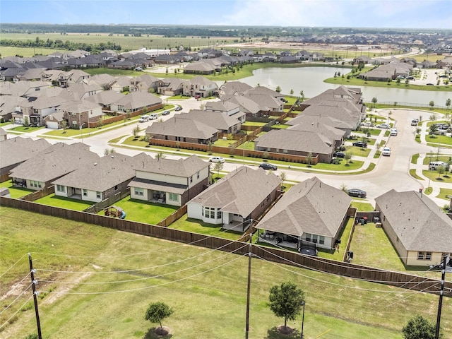 drone / aerial view featuring a water view and a residential view
