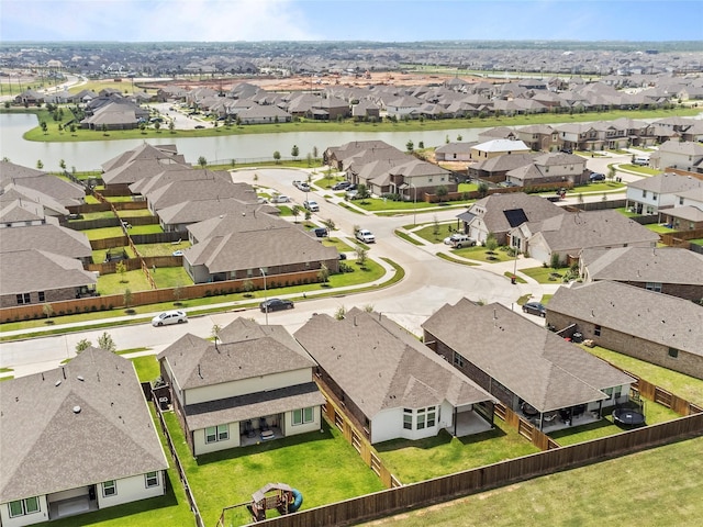 birds eye view of property with a water view and a residential view