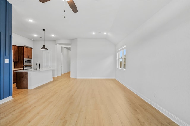 unfurnished living room featuring ceiling fan, recessed lighting, light wood-style floors, and baseboards