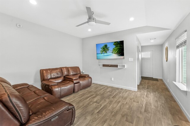 living room featuring wood finished floors, a ceiling fan, recessed lighting, and baseboards