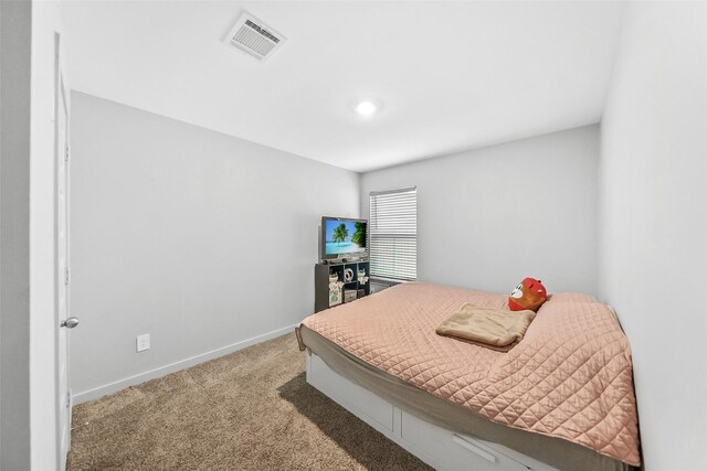carpeted bedroom with baseboards