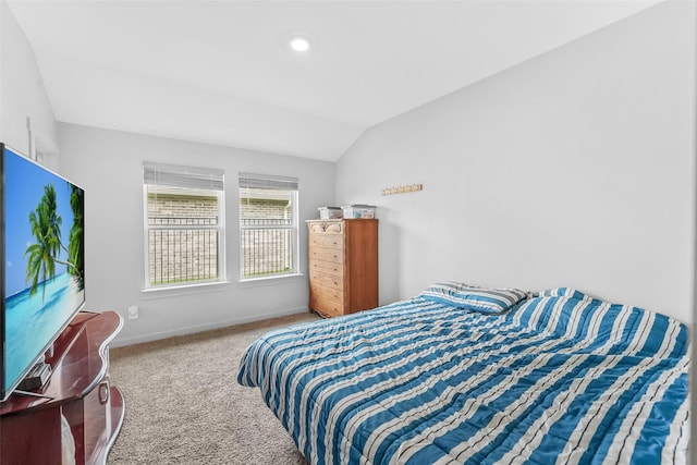 carpeted bedroom featuring vaulted ceiling and baseboards