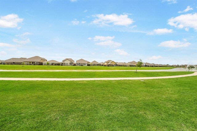 surrounding community featuring a residential view and a lawn