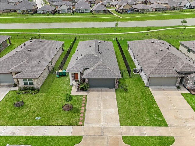 aerial perspective of suburban area with a nearby body of water