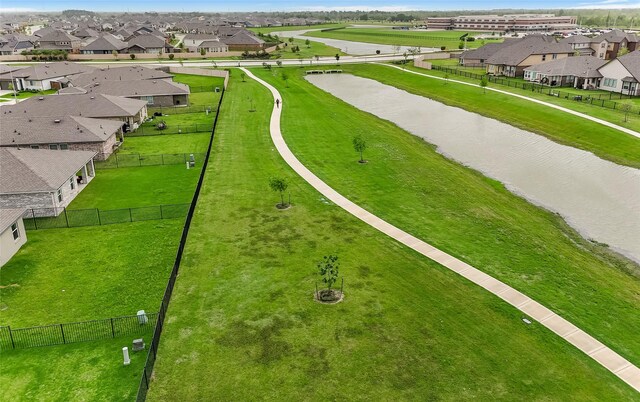 aerial perspective of suburban area with a nearby body of water