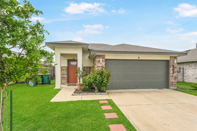 prairie-style home with brick siding, an attached garage, concrete driveway, roof with shingles, and stucco siding