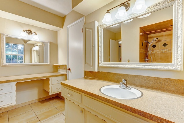 full bathroom featuring a tile shower, tile patterned floors, and vanity