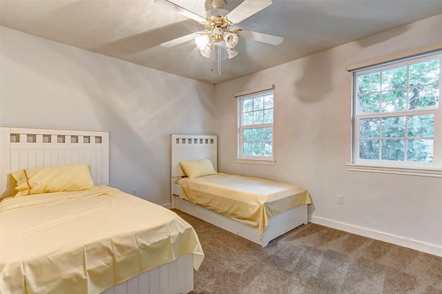carpeted bedroom with baseboards and a ceiling fan