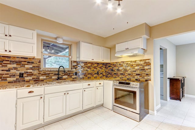 kitchen with light stone counters, white cabinetry, stainless steel range with electric stovetop, under cabinet range hood, and a sink