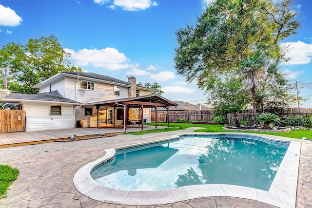 view of swimming pool with a fenced backyard, a wooden deck, a fenced in pool, and a patio