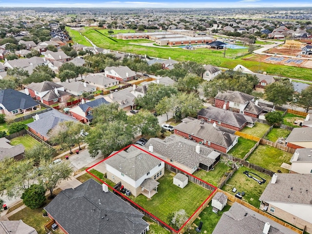 birds eye view of property with a residential view