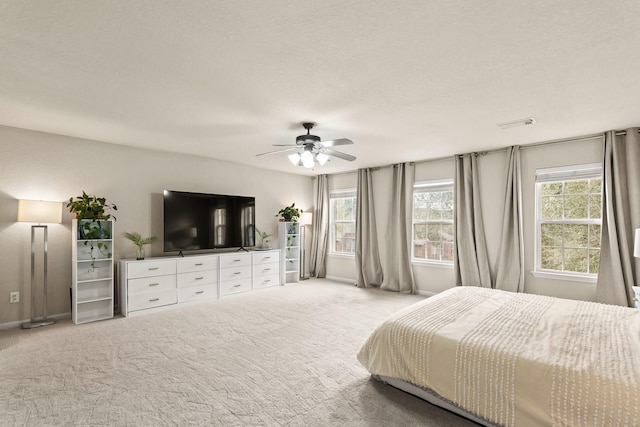 bedroom with visible vents, baseboards, a ceiling fan, and carpet flooring