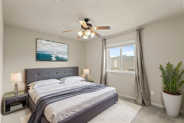 bedroom with ceiling fan and baseboards