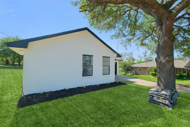 view of property exterior with a yard