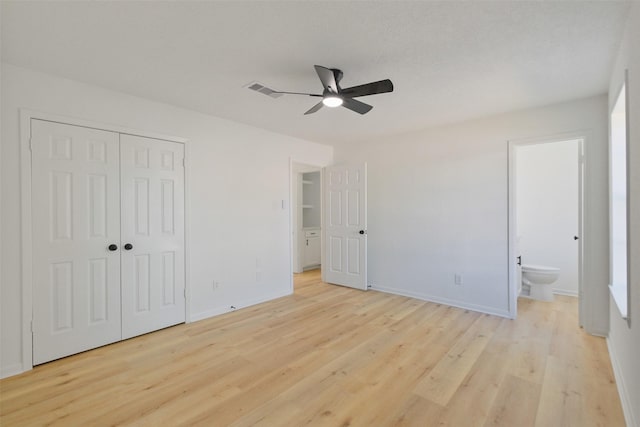 unfurnished bedroom featuring light wood-style flooring, a closet, and baseboards