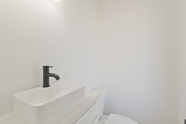 bathroom featuring toilet and a sink