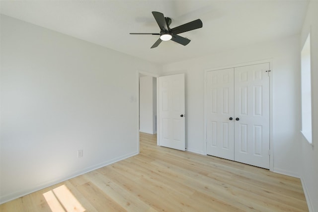 unfurnished bedroom with light wood-style flooring and baseboards
