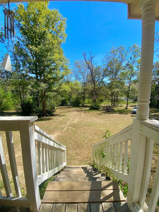 deck with a lawn and covered porch
