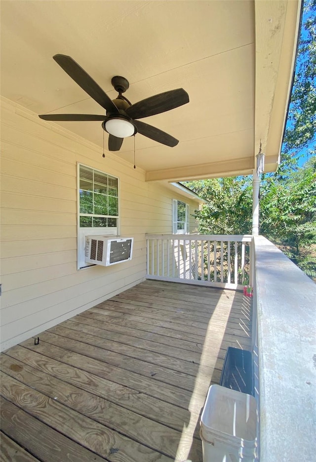 wooden terrace with cooling unit and a ceiling fan