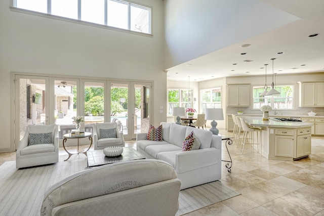 living room featuring french doors and a towering ceiling