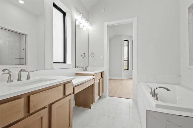 15615 Broadway Bnd, Conroe, TX 77302 - bathroom with marble finish floor, baseboards, a bath, and vanity