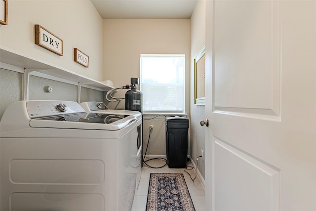 206 Damar Cv, Canyon Lake, TX 78133 - washroom with light tile patterned floors, baseboards, separate washer and dryer, and laundry area