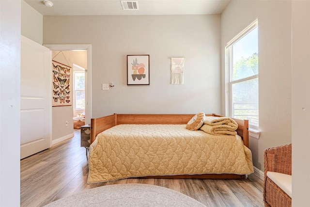 206 Damar Cv, Canyon Lake, TX 78133 - bedroom featuring visible vents, baseboards, and wood finished floors