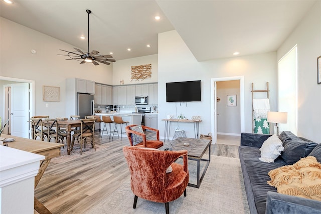 206 Damar Cv, Canyon Lake, TX 78133 - living area with baseboards, a ceiling fan, recessed lighting, light wood finished floors, and a towering ceiling