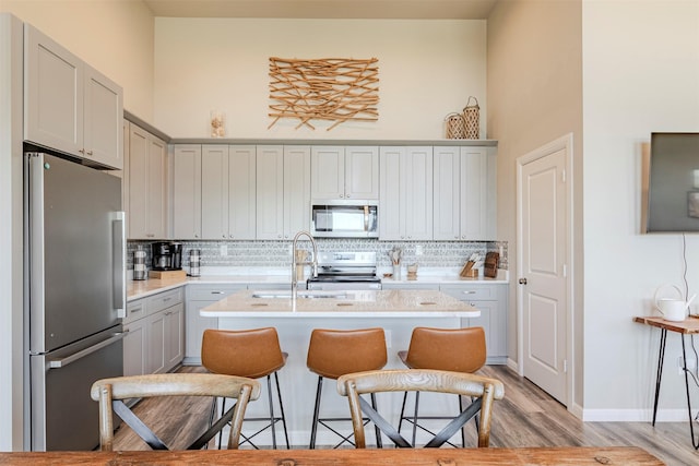 206 Damar Cv, Canyon Lake, TX 78133 - kitchen with stainless steel appliances, light countertops, a high ceiling, and backsplash