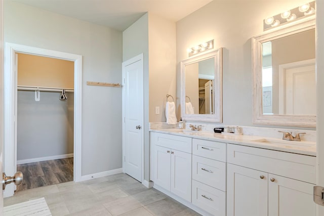 206 Damar Cv, Canyon Lake, TX 78133 - full bath with baseboards, double vanity, a sink, and a walk in closet