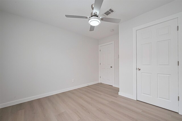 unfurnished bedroom with visible vents, baseboards, light wood finished floors, and a ceiling fan