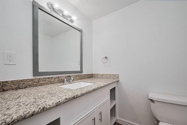 bathroom featuring visible vents, toilet, and vanity