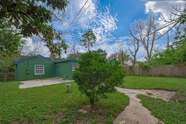 view of yard with fence and a patio