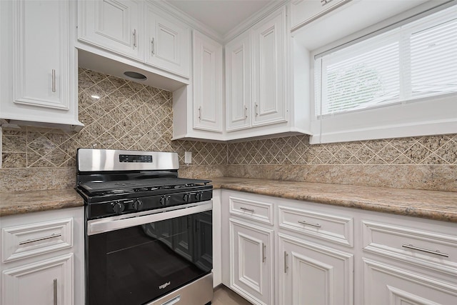 kitchen with backsplash, white cabinetry, stainless steel gas stove, and light stone countertops
