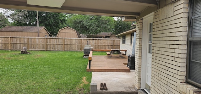 view of yard with a deck and fence