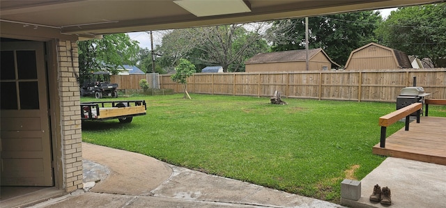 view of yard with a fenced backyard and a wooden deck