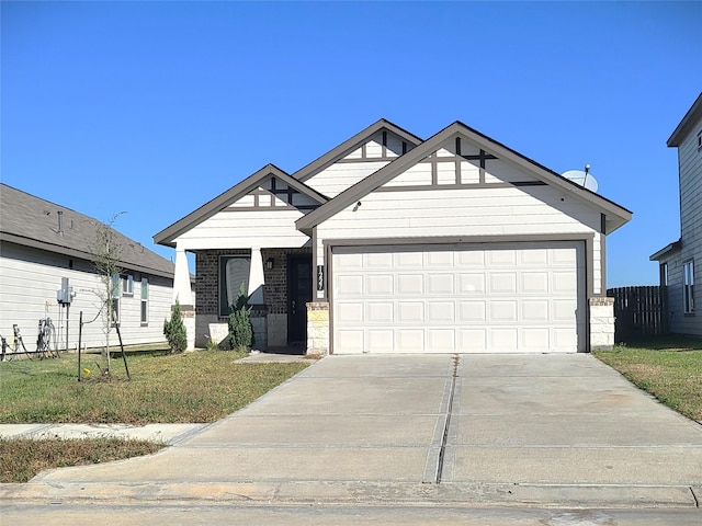 view of front facade featuring an attached garage, driveway, a front yard, and brick siding