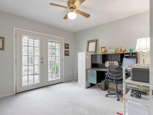 carpeted home office with baseboards, ceiling fan, and french doors