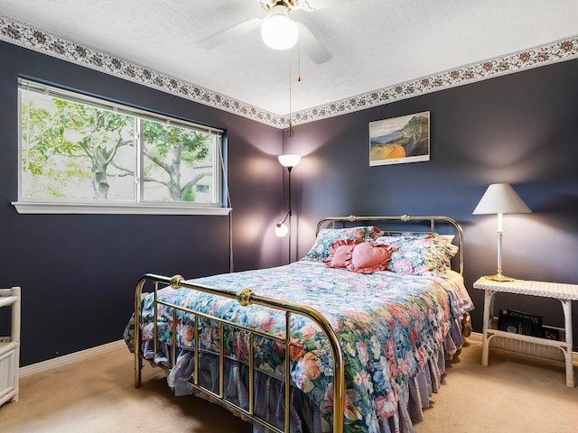 bedroom with baseboards, carpet, a textured ceiling, and ceiling fan