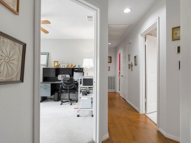 hall featuring recessed lighting, wood finished floors, and visible vents