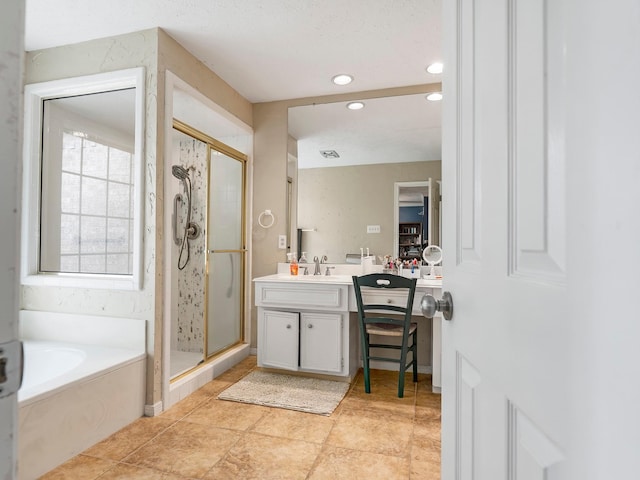 bathroom with recessed lighting, a bath, vanity, and a stall shower