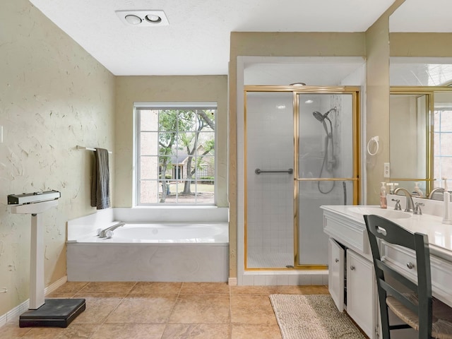 full bath with a bath, vanity, a stall shower, and a textured wall