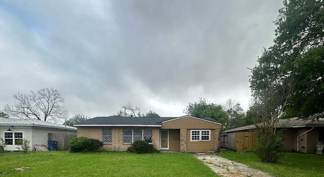 view of front of property with a front yard and brick siding