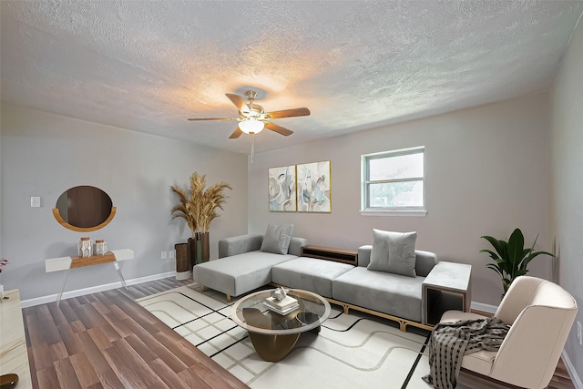 111 N 11th St, Highlands, TX 77562 - living area featuring a textured ceiling, a ceiling fan, wood finished floors, and baseboards