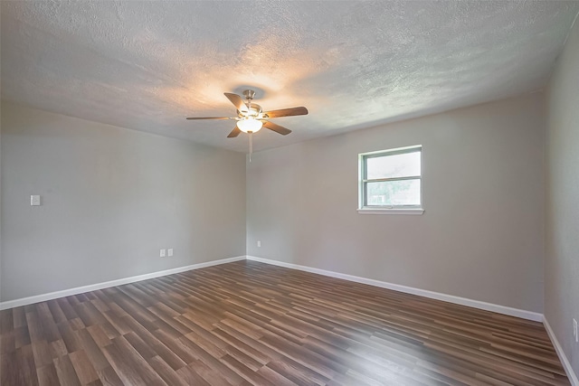 111 N 11th St, Highlands, TX 77562 - empty room with dark wood-style flooring, a textured ceiling, a ceiling fan, and baseboards