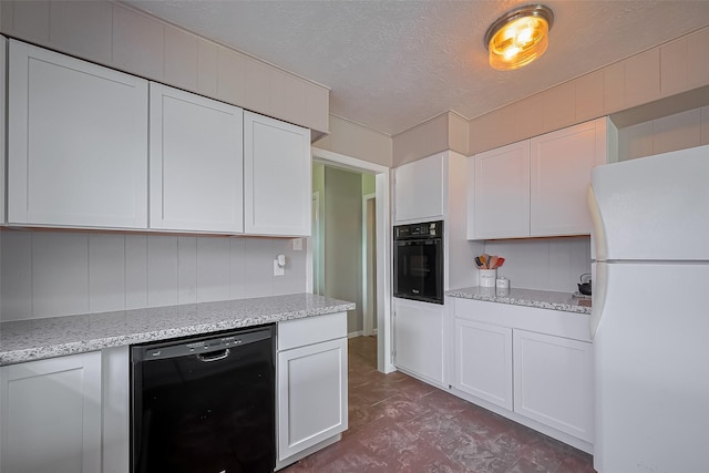 111 N 11th St, Highlands, TX 77562 - kitchen with black appliances, white cabinets, light stone countertops, and a textured ceiling