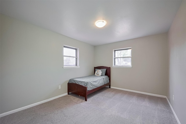 111 N 11th St, Highlands, TX 77562 - carpeted bedroom featuring multiple windows and baseboards