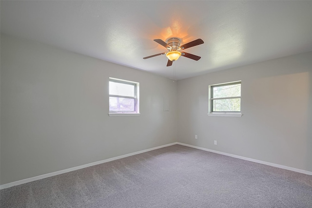 111 N 11th St, Highlands, TX 77562 - empty room featuring healthy amount of natural light, ceiling fan, baseboards, and carpet